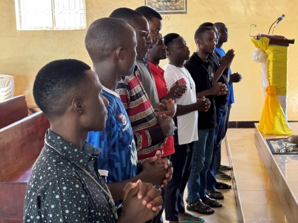 Edison, Hillary, Robert, Desdery, Emmanuel, Luis, Livinus, Polycarp, and Linus practice in preparation for their profession of first vows.